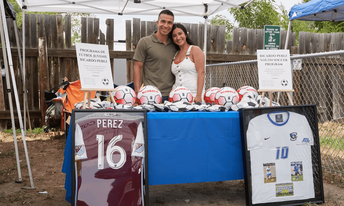 Ricardo and Kianna at a soccer event tent.