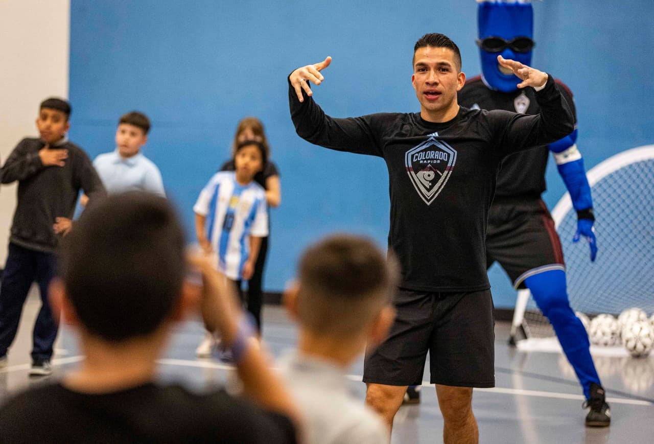 Professional soccer player coaching young athletes
